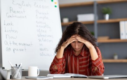 Woman looking down at her notes in stress